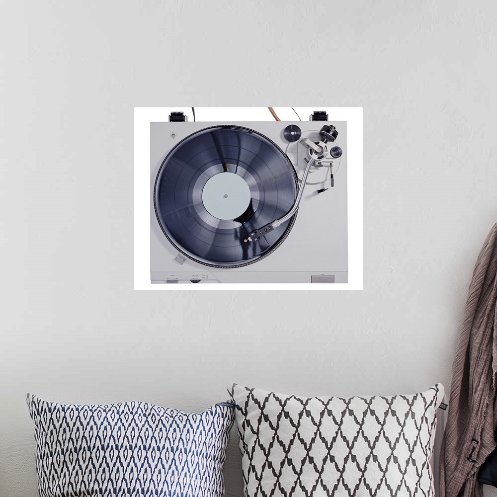 A bohemian room featuring This photograph is taken of a vintage record player looking down at the record as it plays on the...