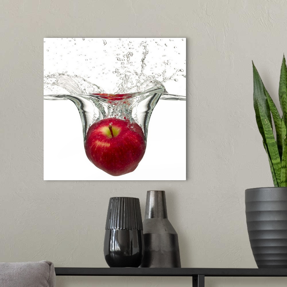 A modern room featuring Red apple splashing in water
