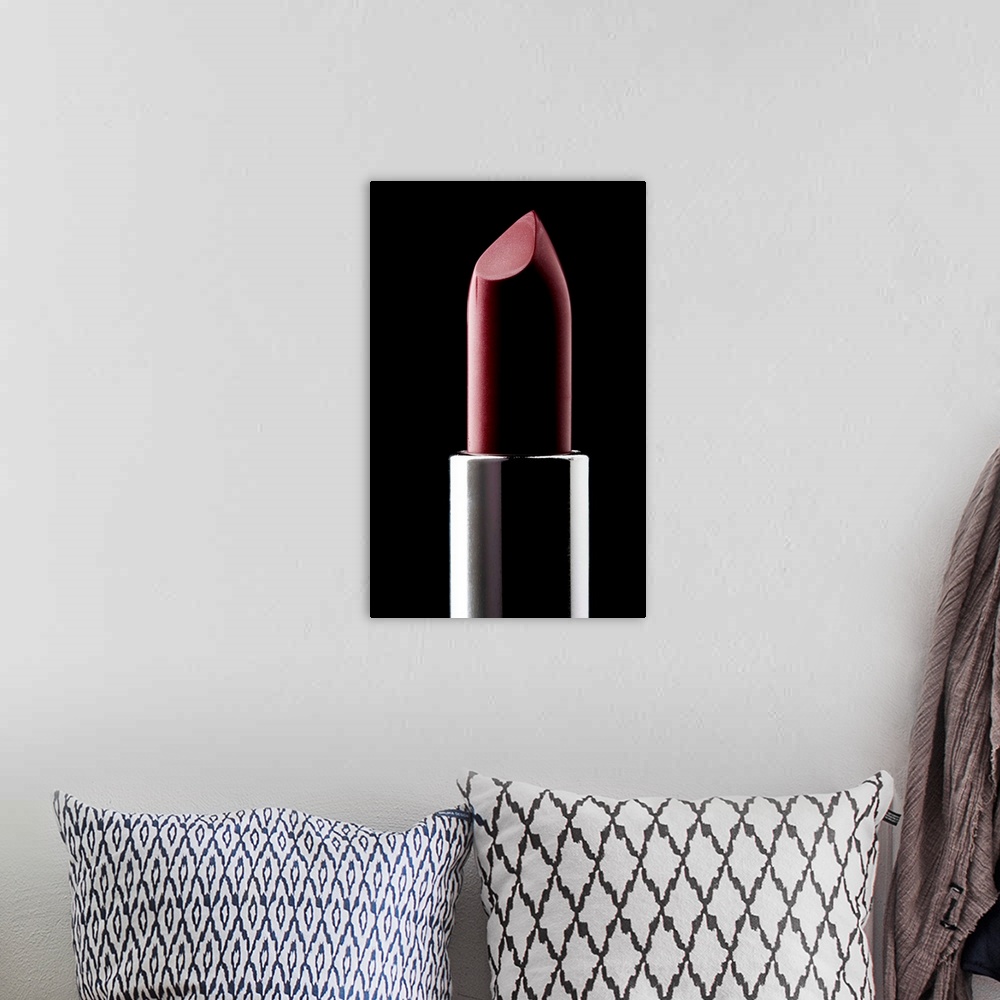 A bohemian room featuring Red lipstick against black background, close-up