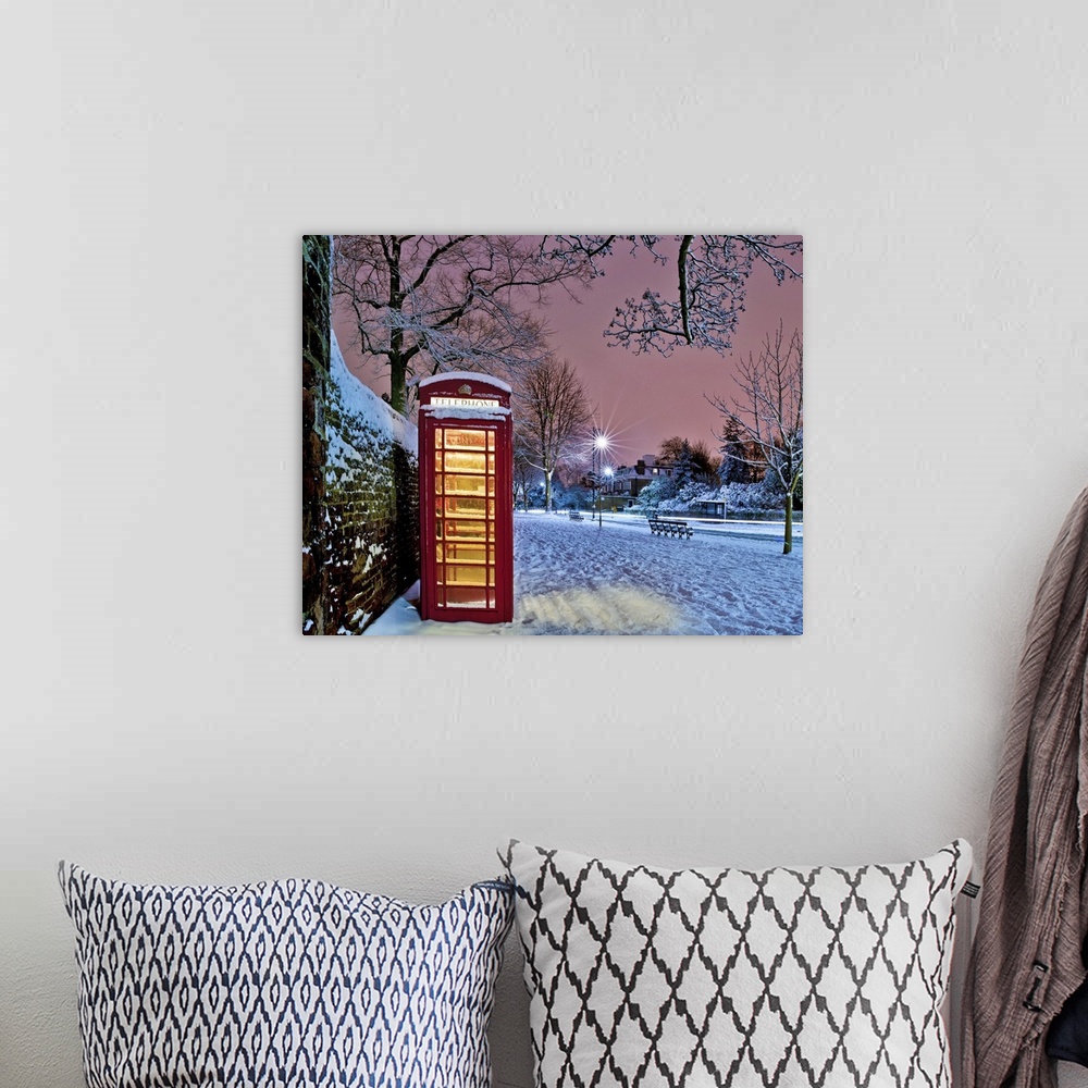 A bohemian room featuring Red phone box covered in snow in Hampstead, North London.