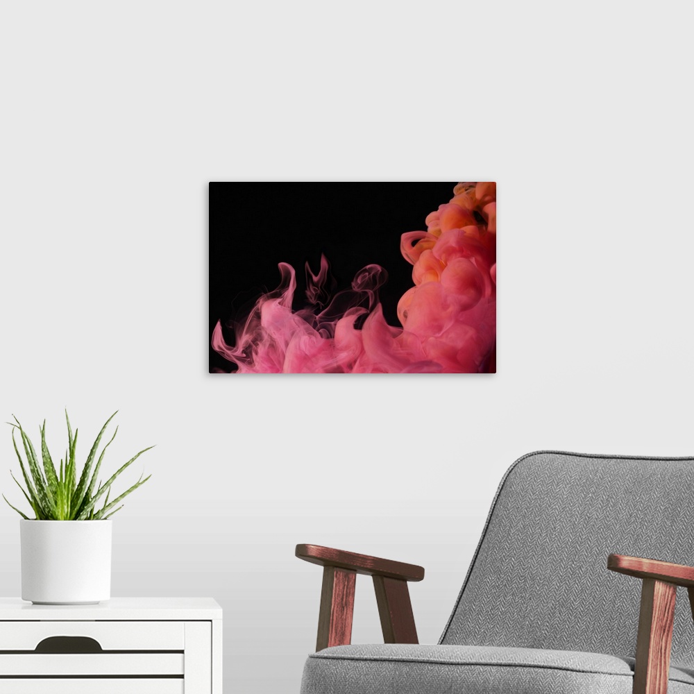 A modern room featuring Red colored smoke that rises up and mixes in beautiful abstractions in a dark environment