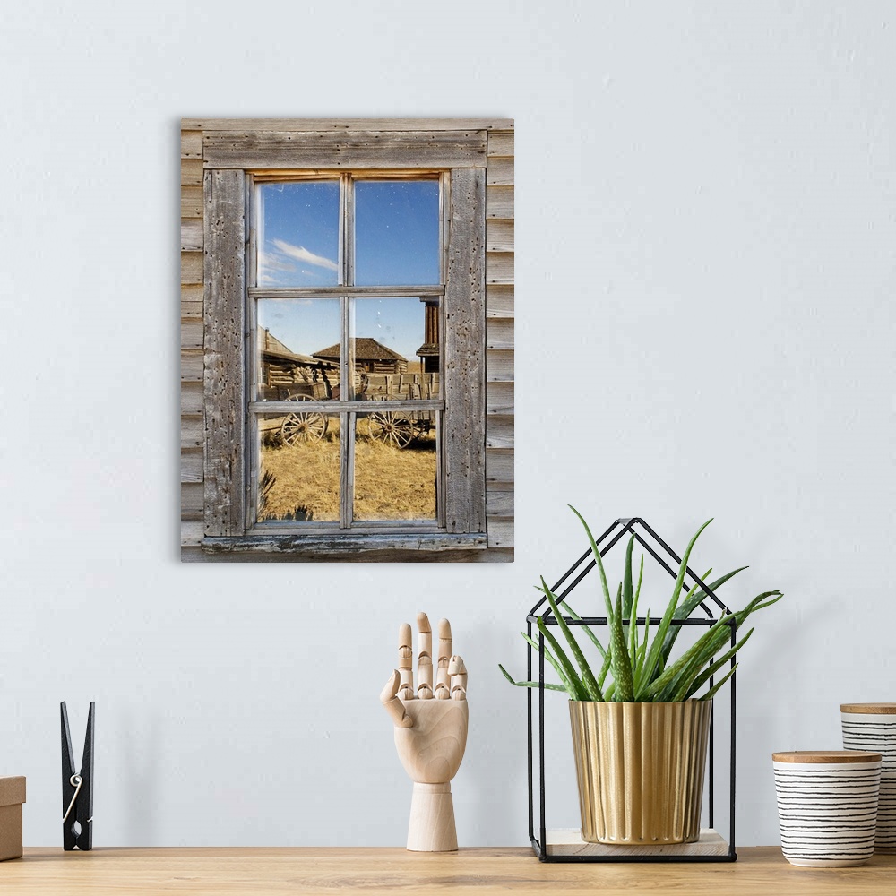 A bohemian room featuring Reflection in window of old western town
