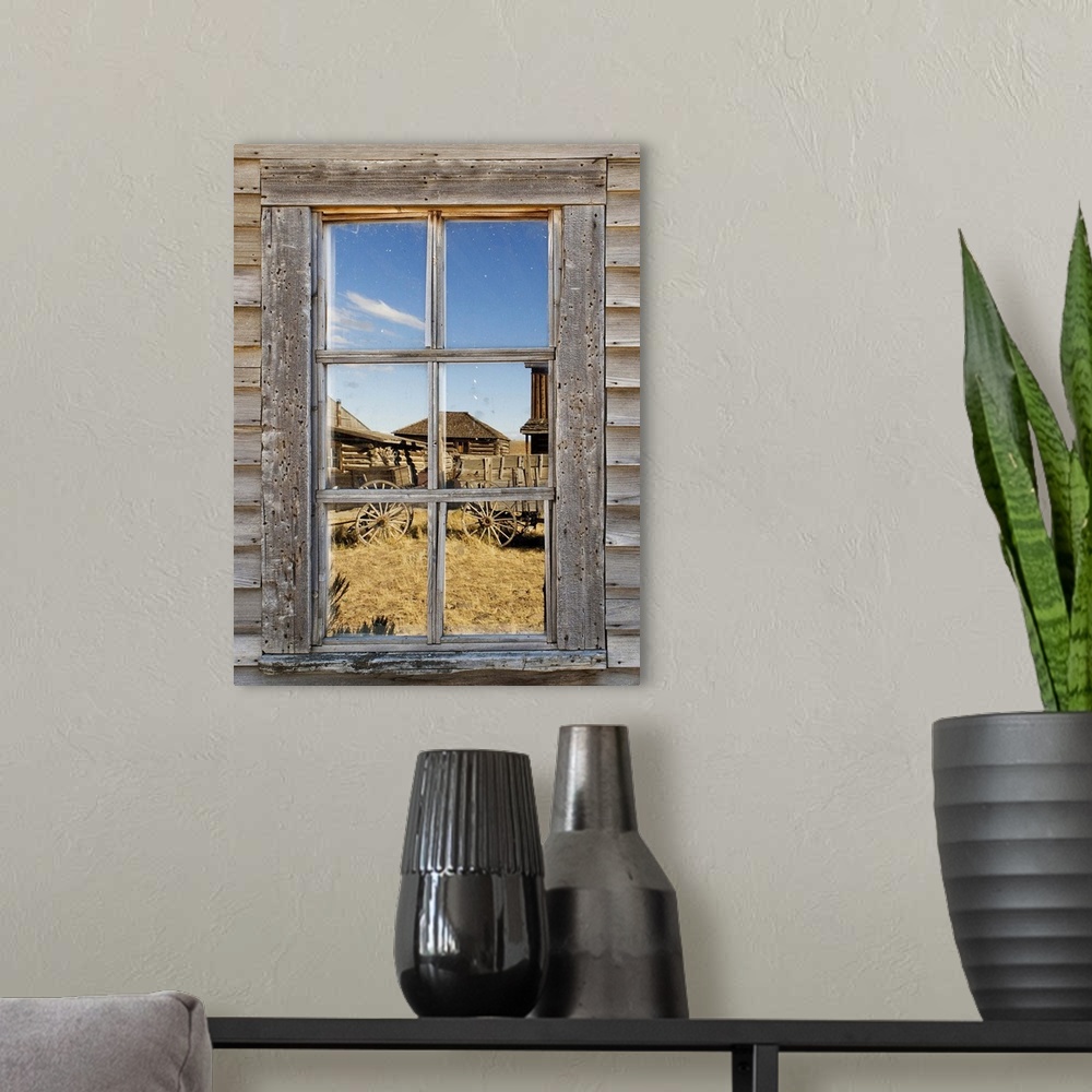 A modern room featuring Reflection in window of old western town