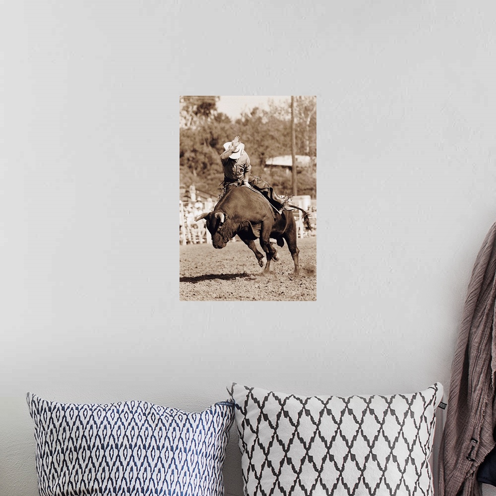 A bohemian room featuring Rider about to fall off bucking bull