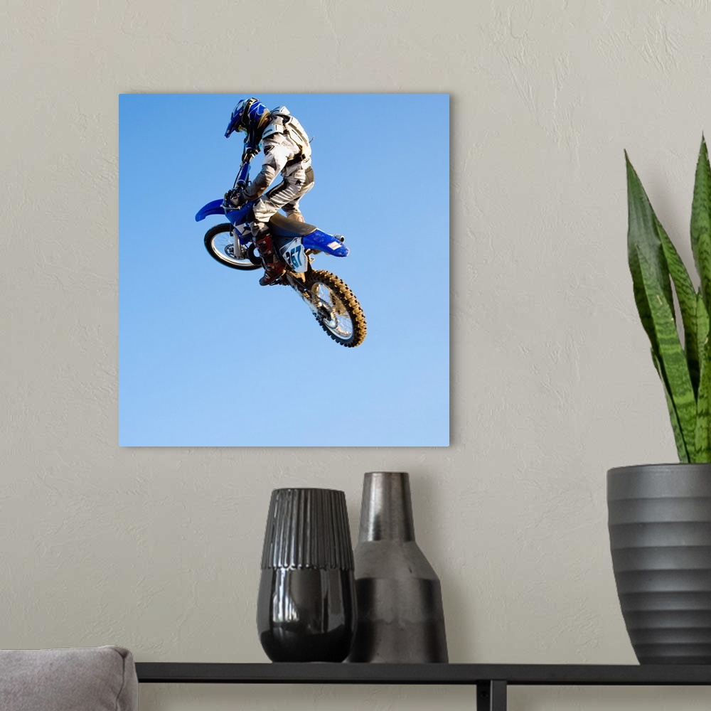 A modern room featuring Rider jumping dirt bike