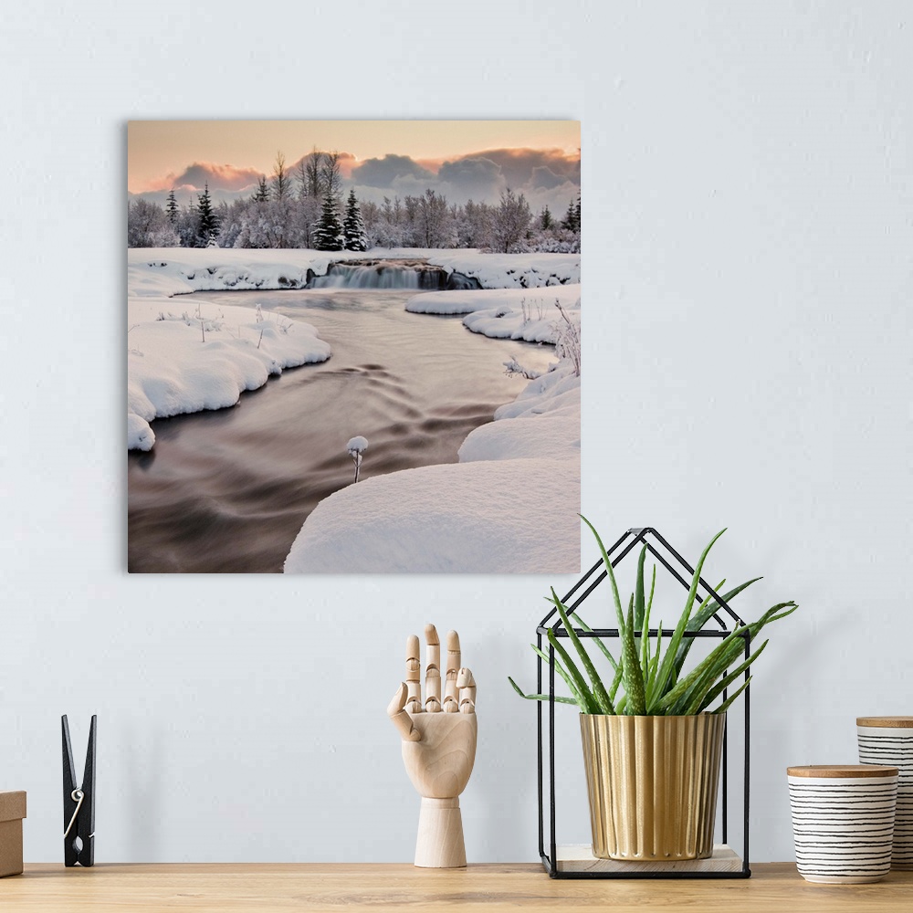 A bohemian room featuring River covered with snow at winter, Iceland.