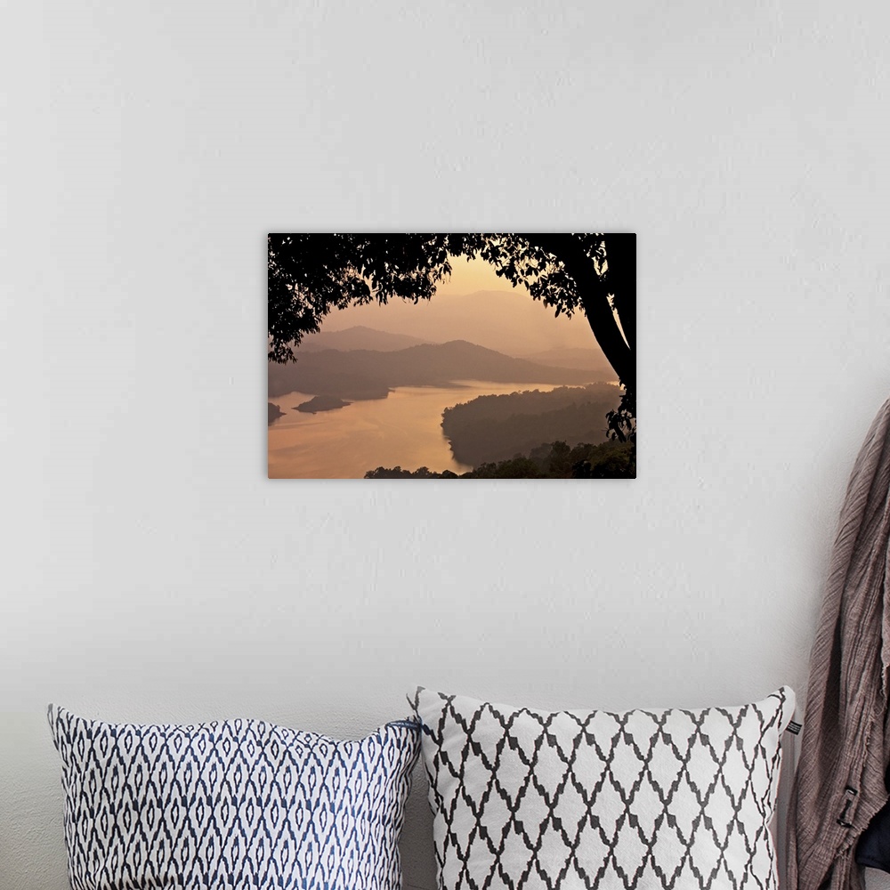 A bohemian room featuring View of river Sharavathi with mountain in background and silhouette tree in foreground at mist ev...