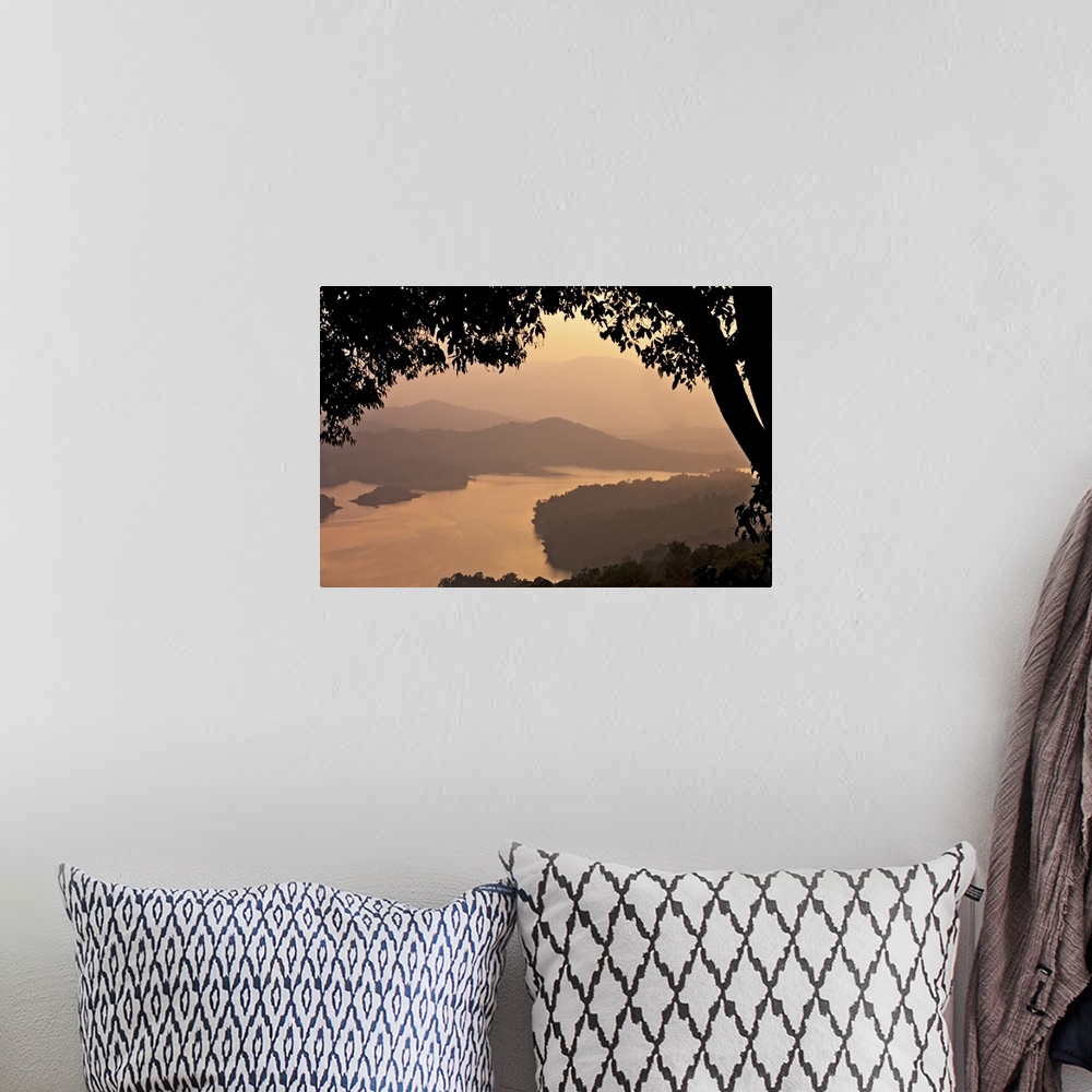 A bohemian room featuring View of river Sharavathi with mountain in background and silhouette tree in foreground at mist ev...