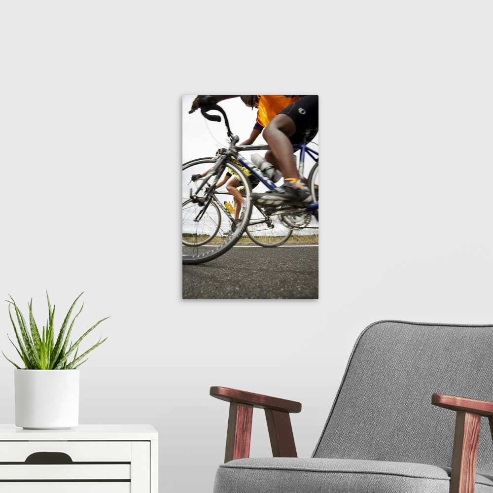 A modern room featuring Road cyclists in action, side view (surface level)