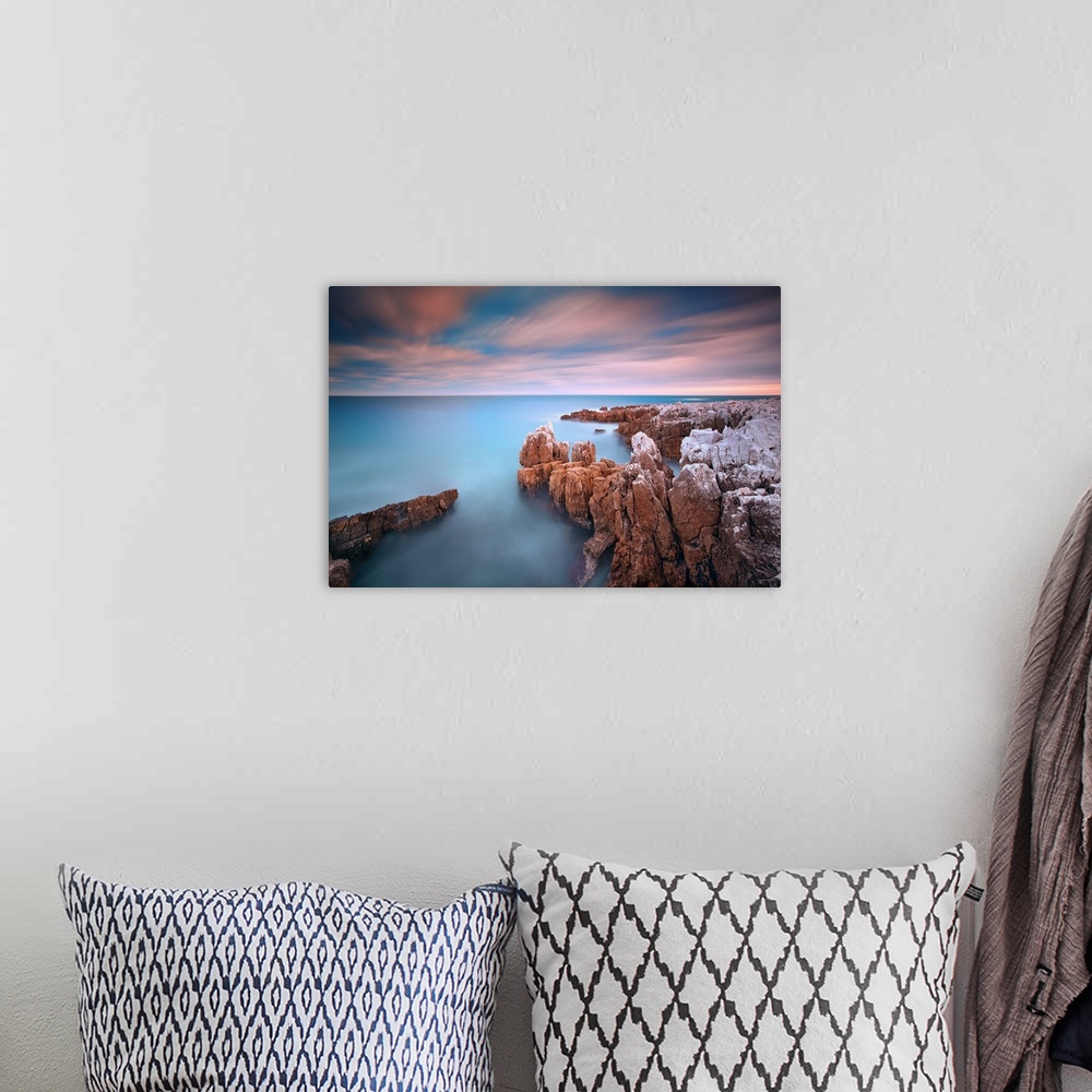 A bohemian room featuring Rocks in sea at sunset at Cap d'Antibes (French Riviera).