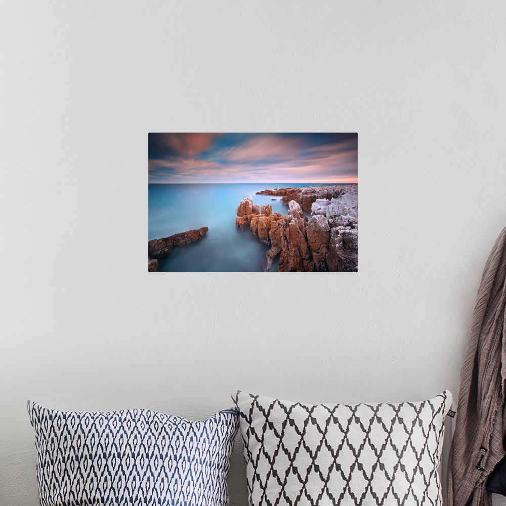 A bohemian room featuring Rocks in sea at sunset at Cap d'Antibes (French Riviera).