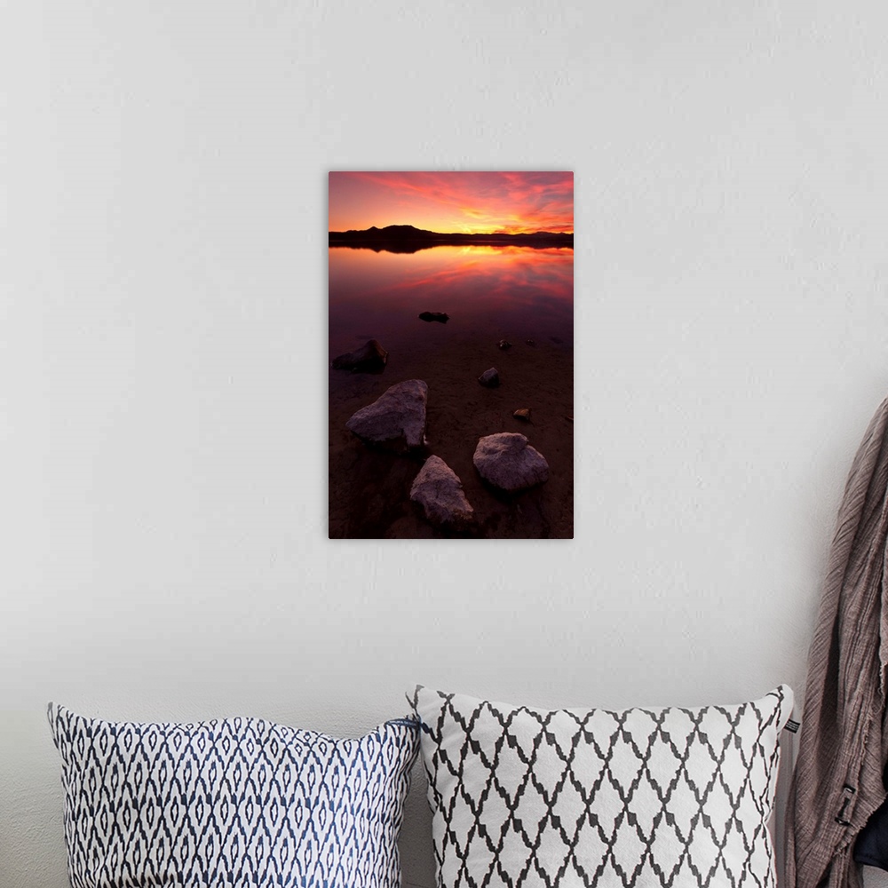 A bohemian room featuring Rocks on beach at sunset.