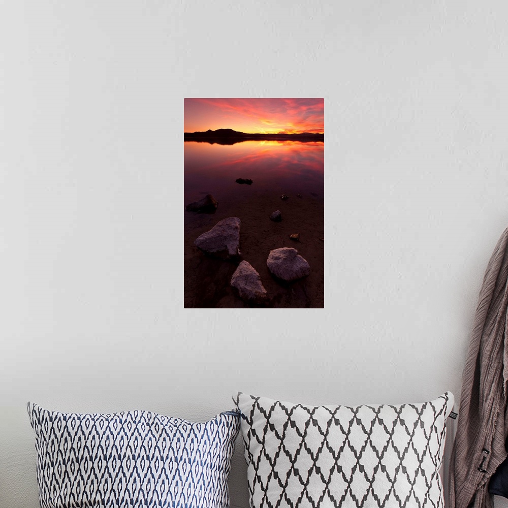 A bohemian room featuring Rocks on beach at sunset.
