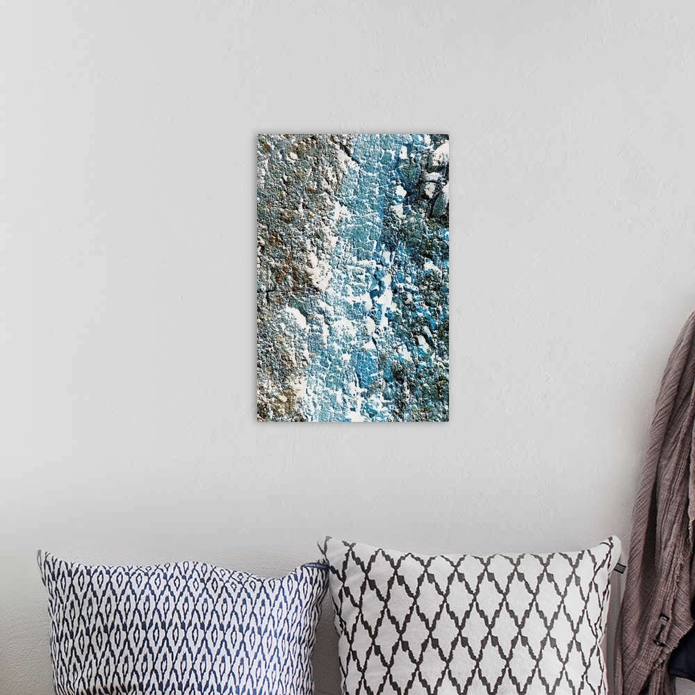 A bohemian room featuring Tall printed canvas of the up close of a rock wall.