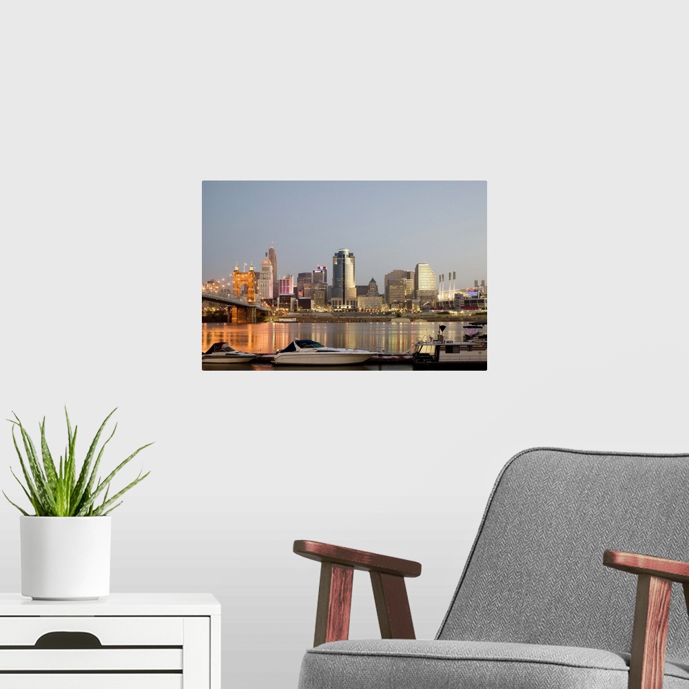A modern room featuring Roebling Suspension Bridge (b.1876) over the Ohio River and skyline