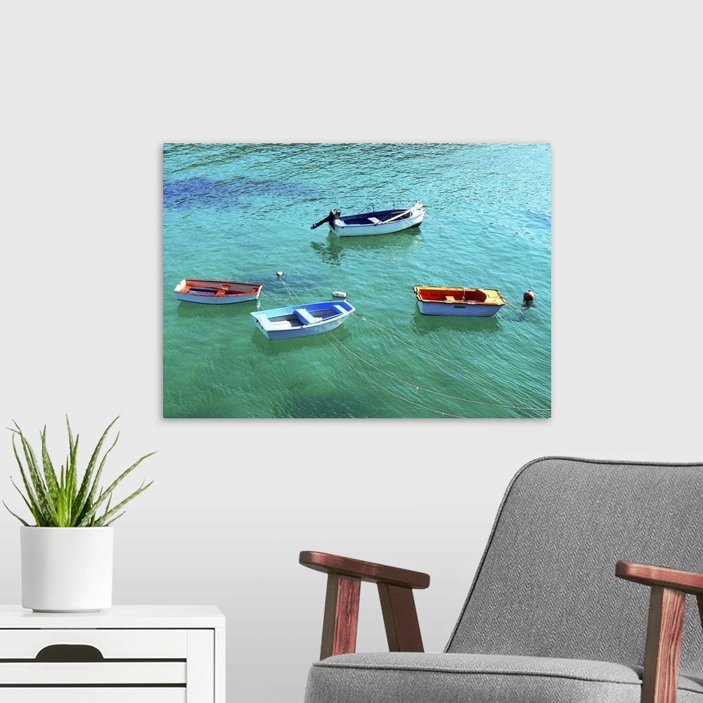 A modern room featuring Row boats on turquoise water