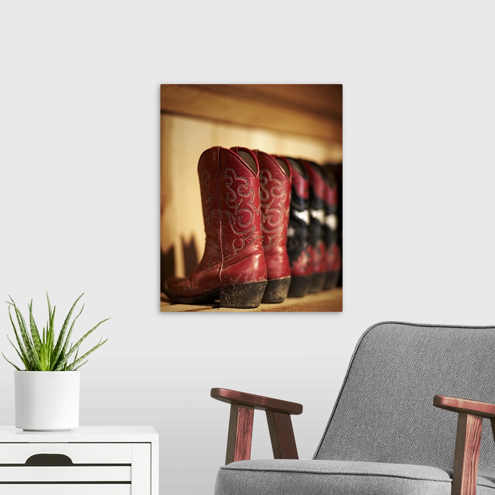 A modern room featuring Row of cowboy boots sitting on a shelf