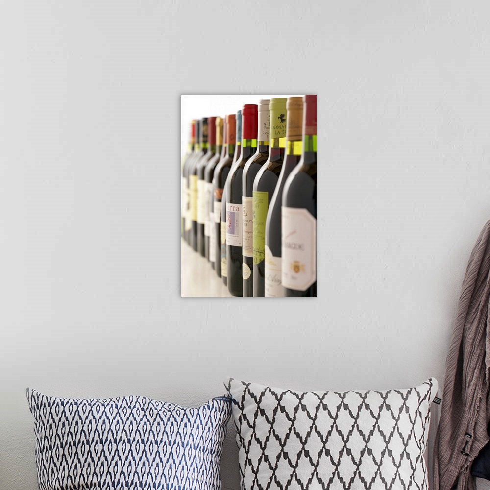 A bohemian room featuring Artwork perfect for the home or kitchen showing a line of red wine bottles taken at an angle with...