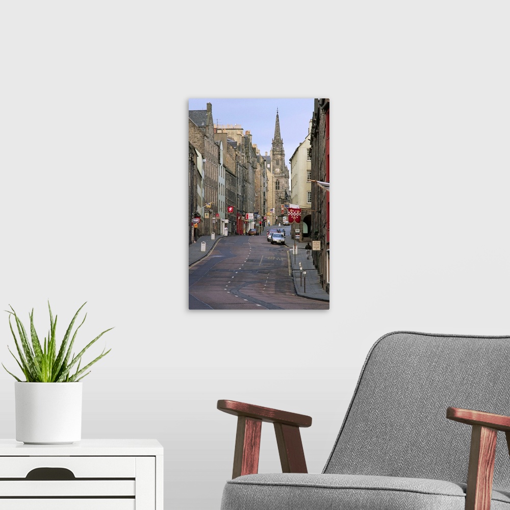 A modern room featuring Saint Giles' Cathedral towers over the buildings of the Royal Mile in the Old Town district of Ed...