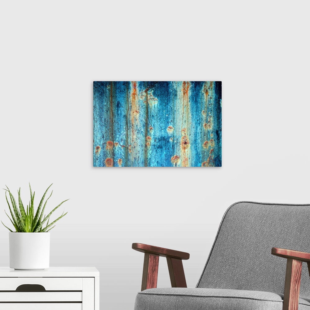 A modern room featuring Large photograph shows a rough textured surface that has been heavily affected by oxidation and c...