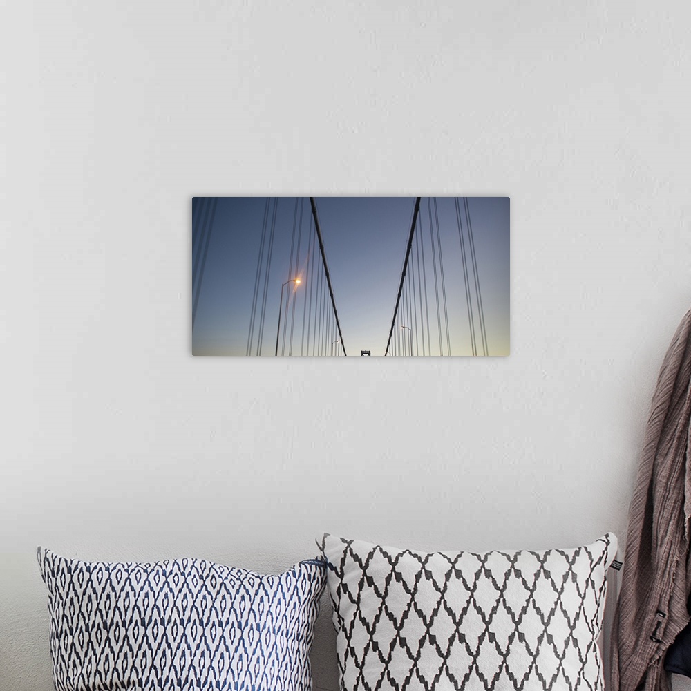 A bohemian room featuring Suspension cables on the Bay Bridge at dusk.