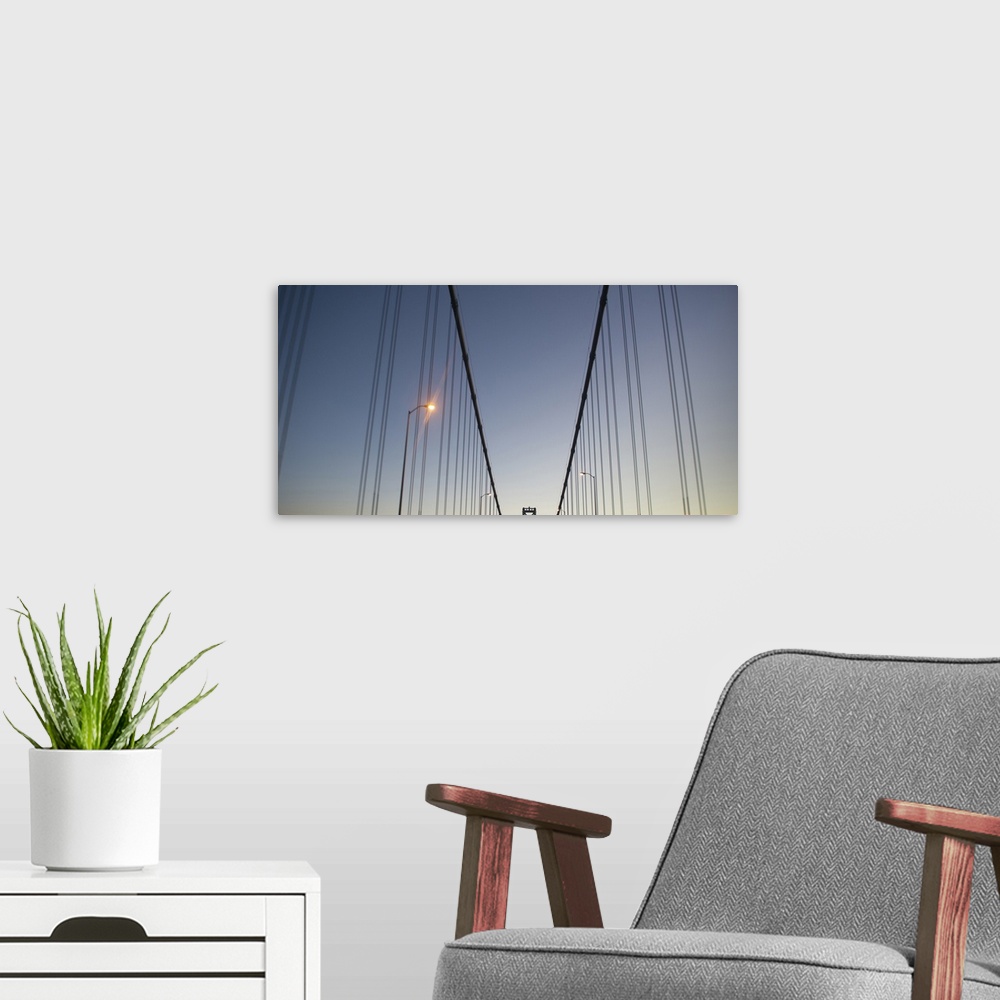 A modern room featuring Suspension cables on the Bay Bridge at dusk.