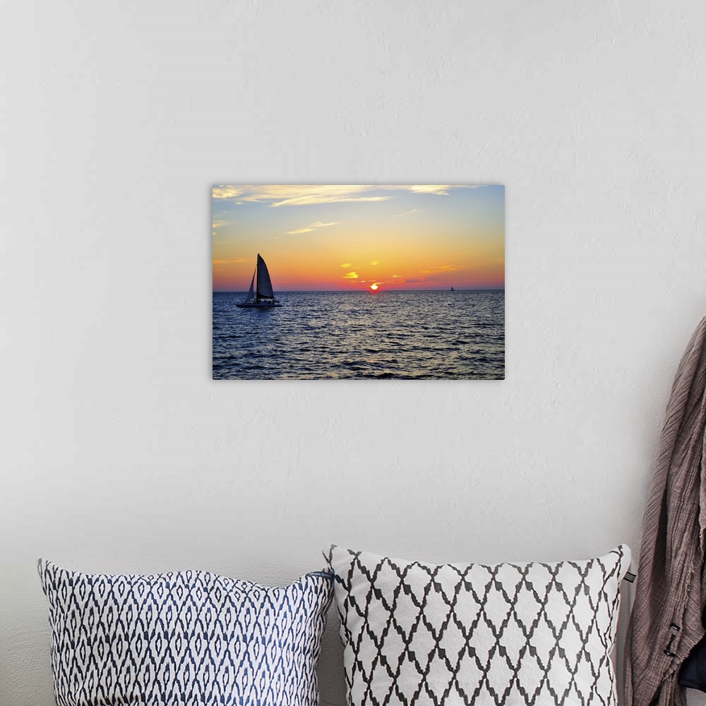 A bohemian room featuring Sail boat on sea at sunset in Gulf of Mexico.