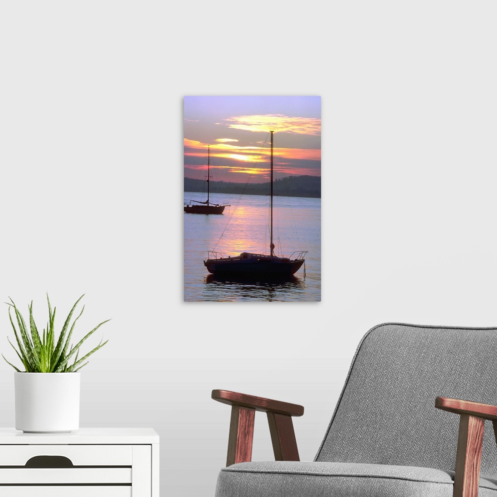 A modern room featuring Sailboats in water at sunrise
