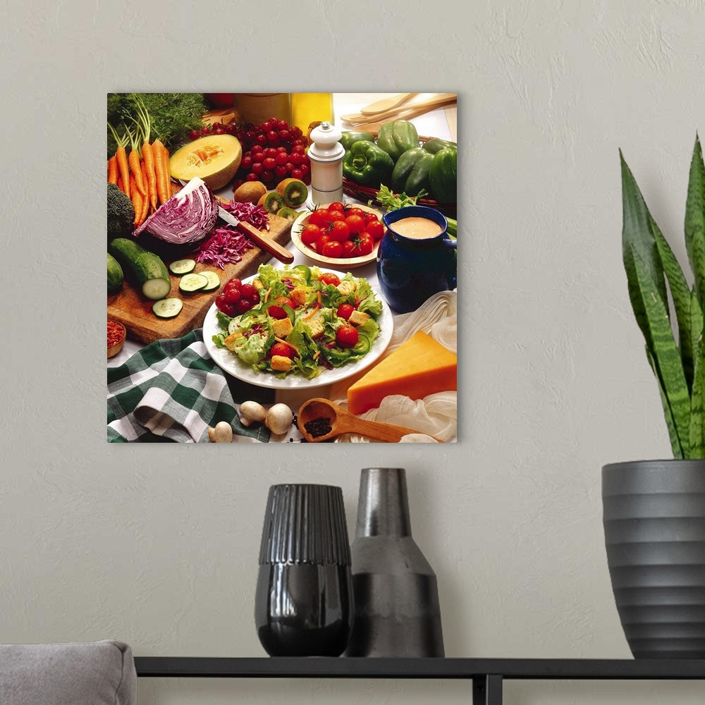 A modern room featuring A photographic still life of a table crowded with fresh fruits and vegetables such as cabbage, cu...