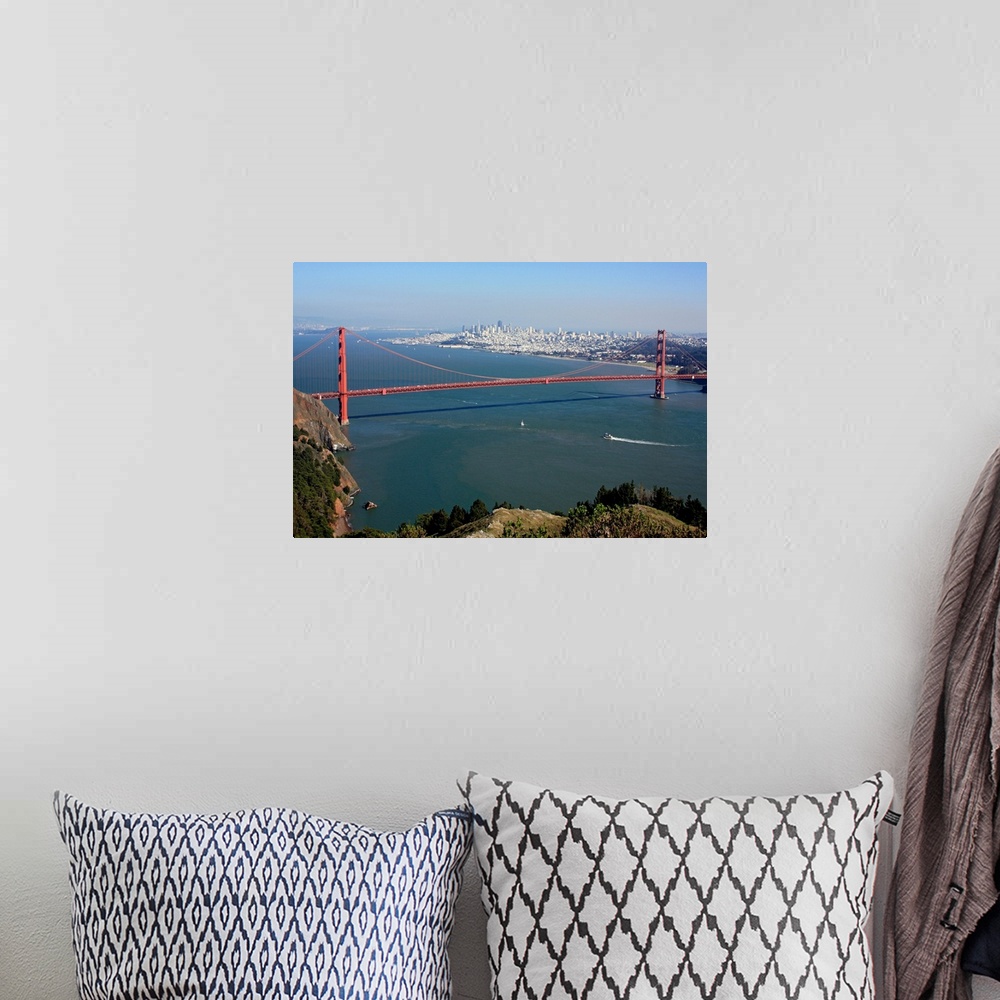 A bohemian room featuring This is an aerial landscape photograph of the suspension bridge, bay, and distant city skyline on...