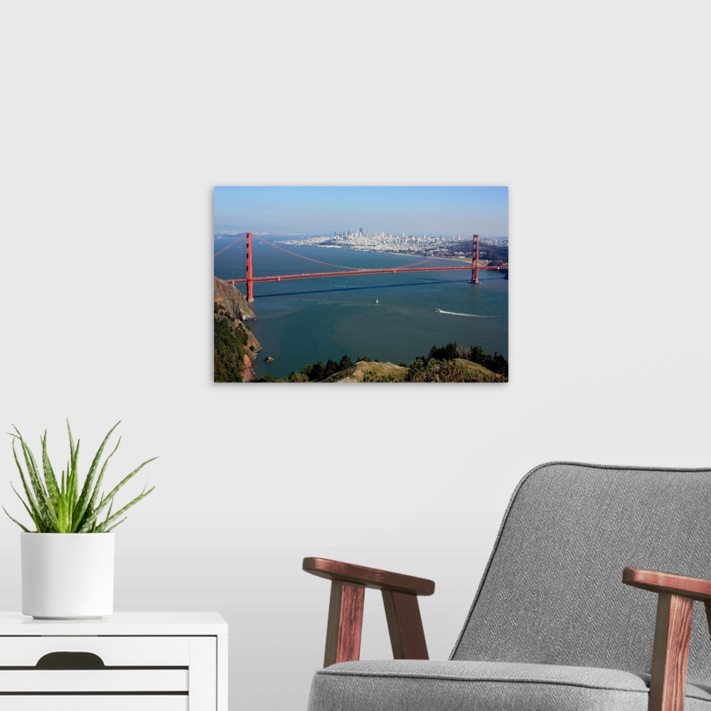 A modern room featuring This is an aerial landscape photograph of the suspension bridge, bay, and distant city skyline on...