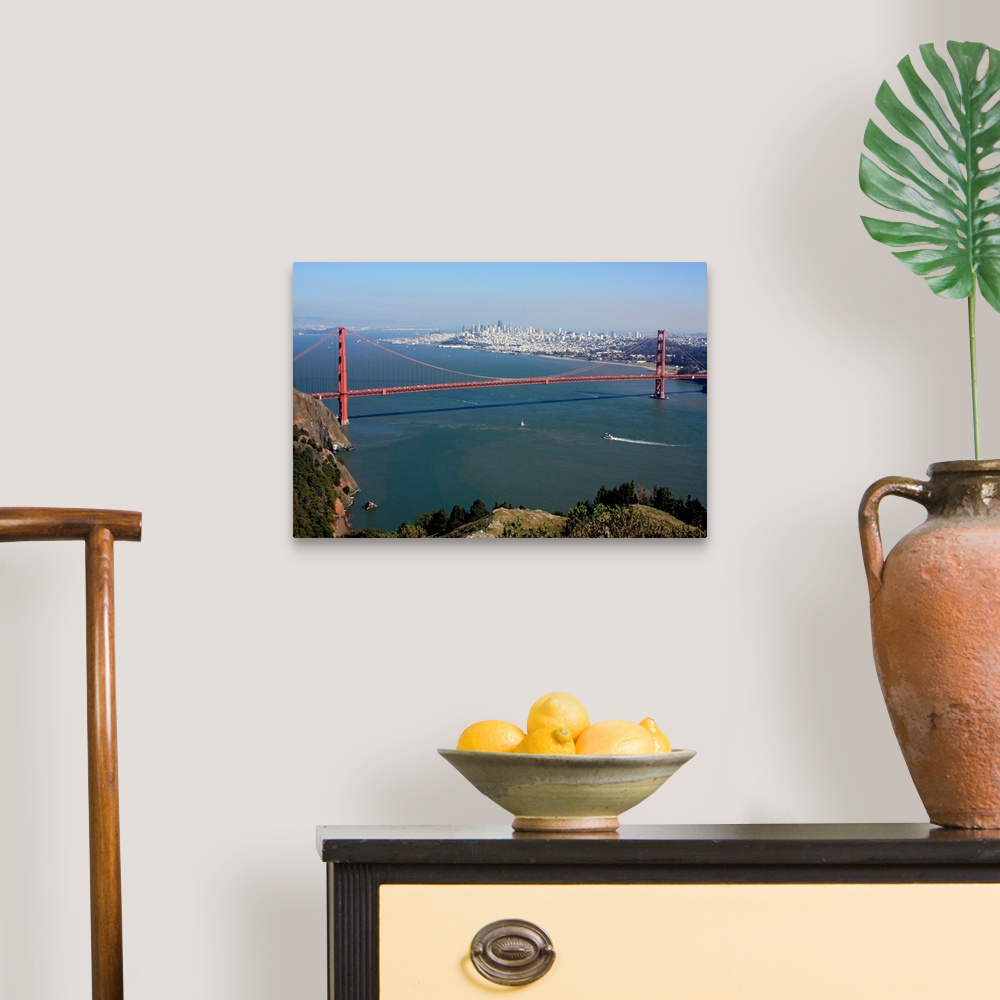 A traditional room featuring This is an aerial landscape photograph of the suspension bridge, bay, and distant city skyline on...