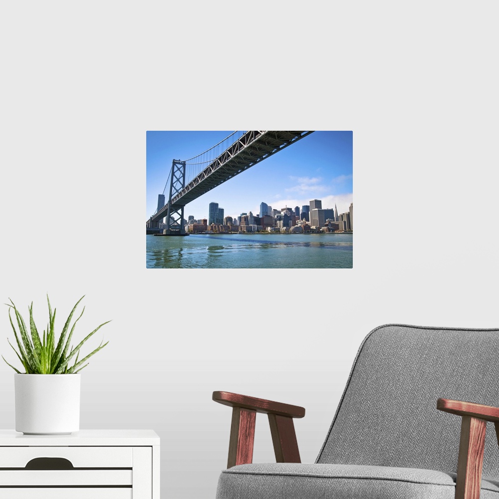 A modern room featuring San Franciscos Bay bridge as it connects with Embarcadero.