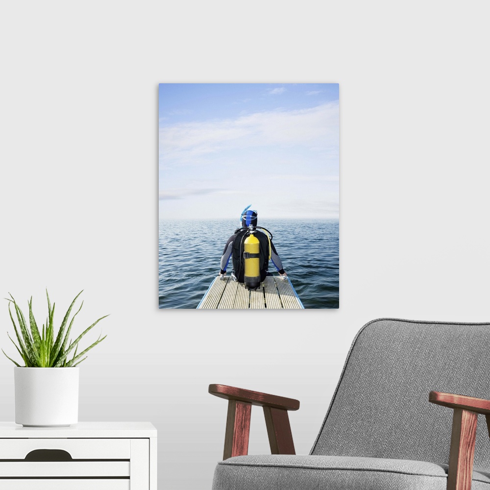 A modern room featuring Scuba diver looking out to sea