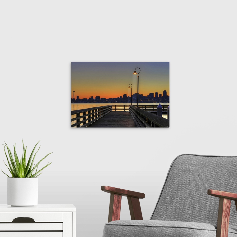 A modern room featuring Horizontal photograph on a giant wall hanging looking down the lit Seacrest Park Fishing Pier in ...