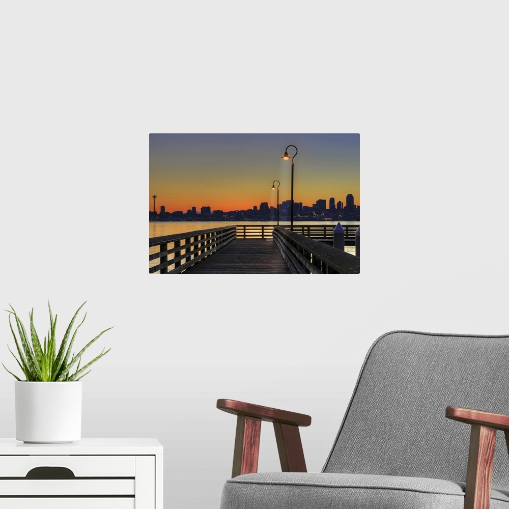 A modern room featuring Horizontal photograph on a giant wall hanging looking down the lit Seacrest Park Fishing Pier in ...