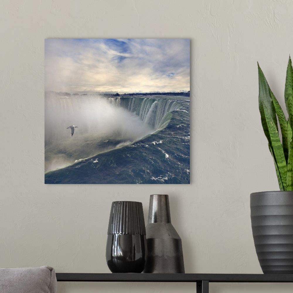 A modern room featuring Seagull flying over misty Horseshoe Falls in winter time.