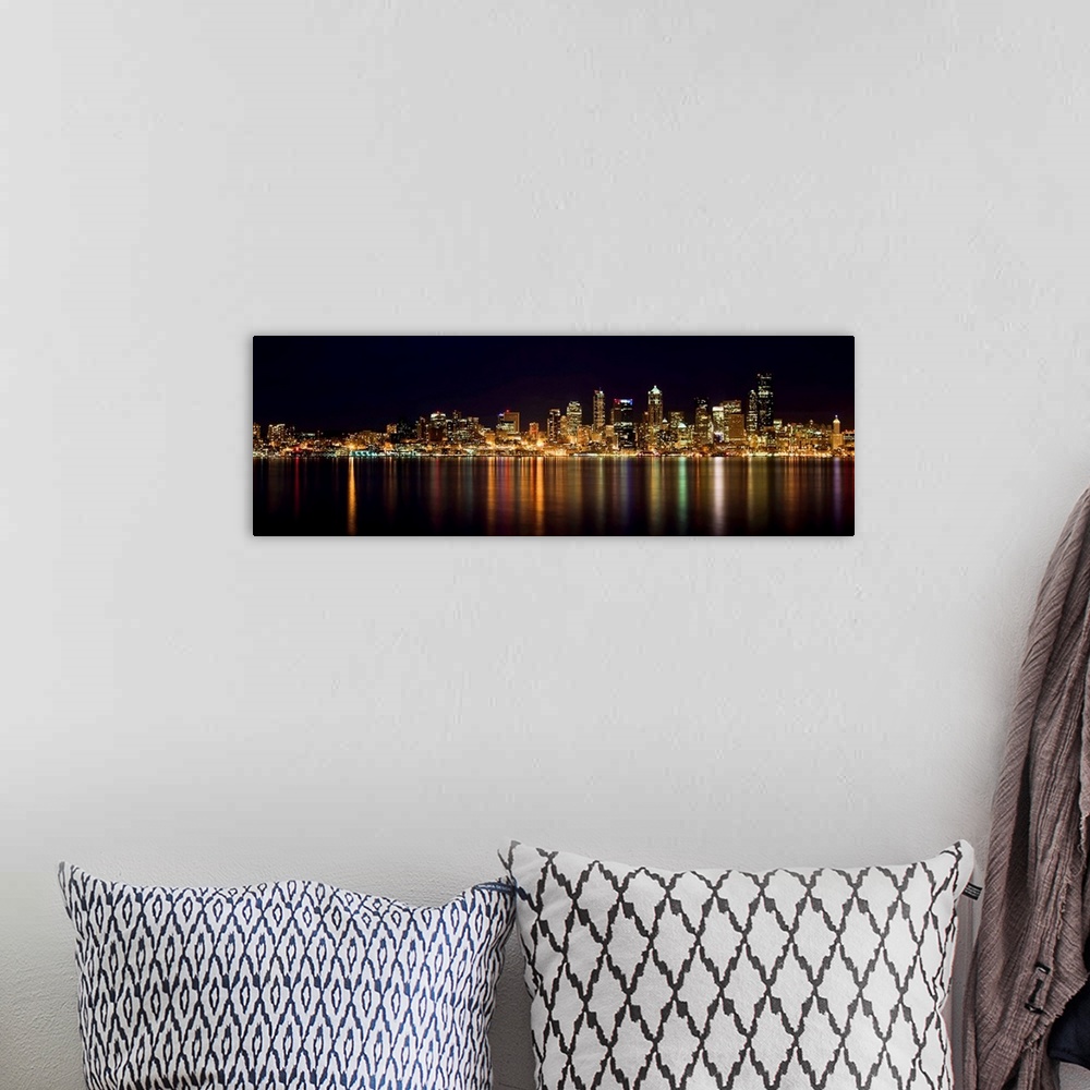 A bohemian room featuring Nighttime shot of downtown Seattle at night with lights of city reflected in water of Puget Sound.