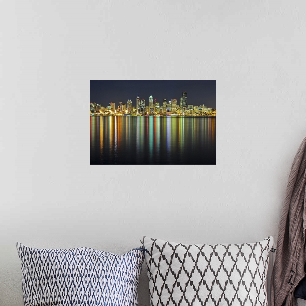 A bohemian room featuring Large photograph taken of the Seattle skyline at night with the buildings lit up and reflecting i...