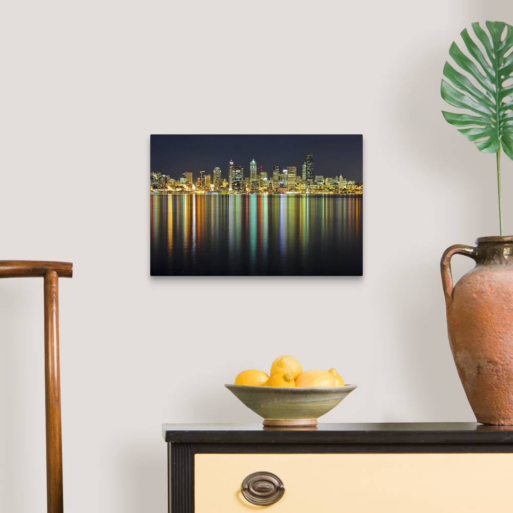 A traditional room featuring Large photograph taken of the Seattle skyline at night with the buildings lit up and reflecting i...