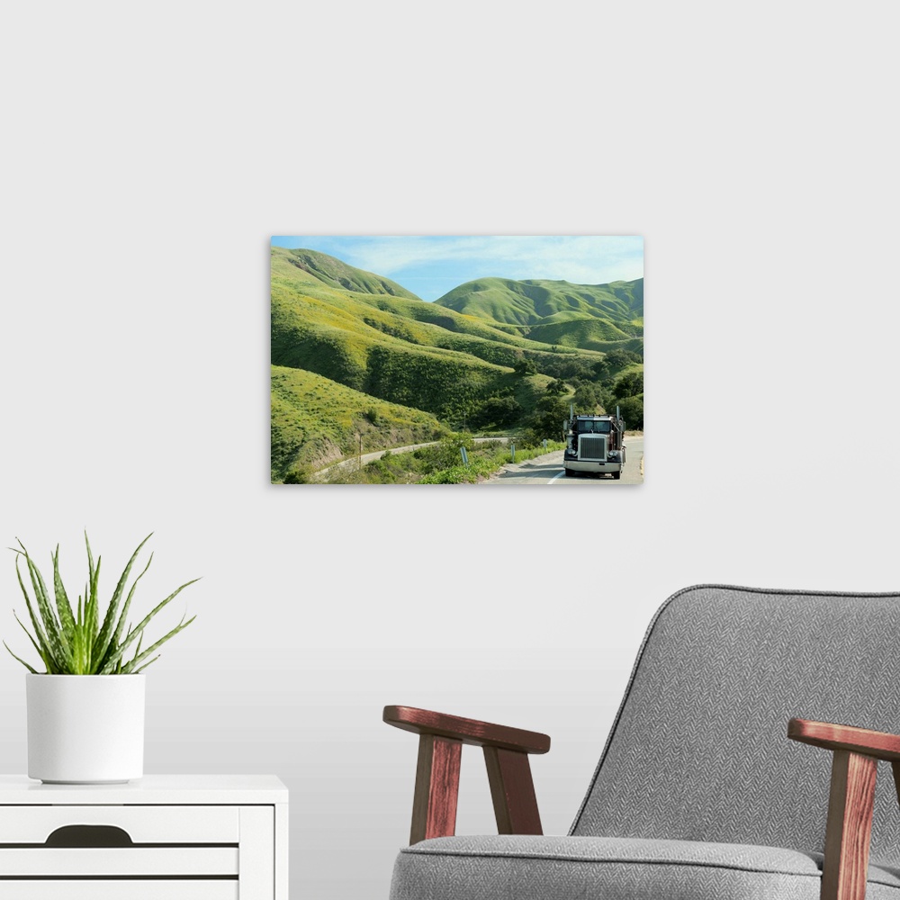 A modern room featuring Semi-truck driving on remote highway