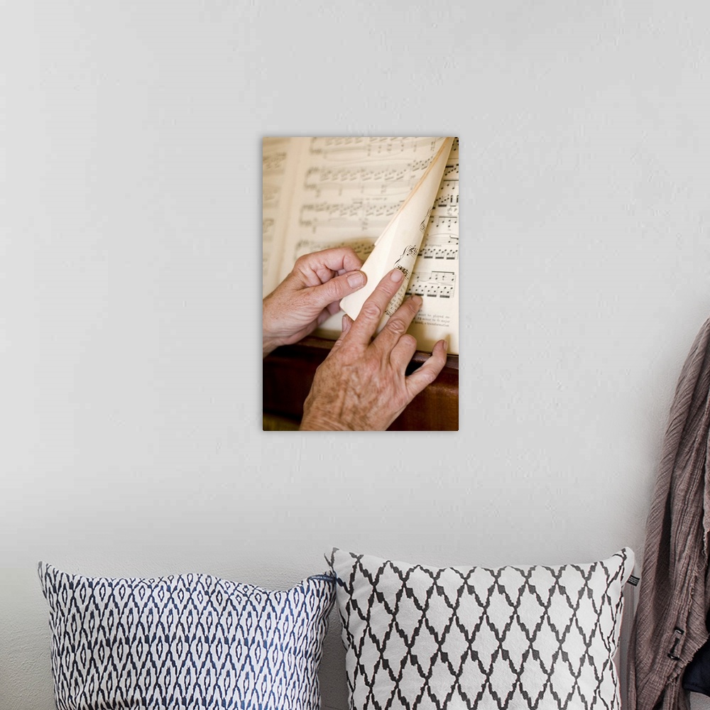 A bohemian room featuring Senior's hands turning page of sheet music