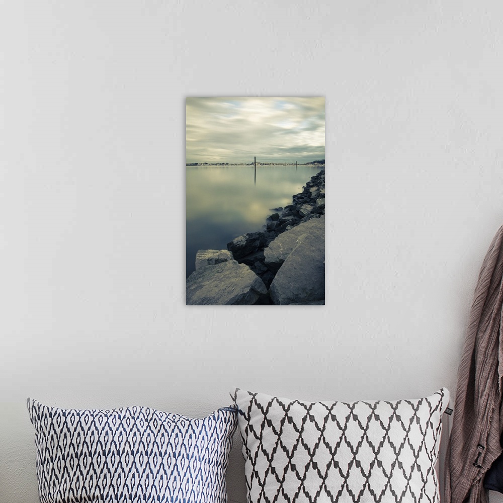 A bohemian room featuring Scenic view on shoreline harbor with boat pole in atlantic ocean in long exposure, Basque country...