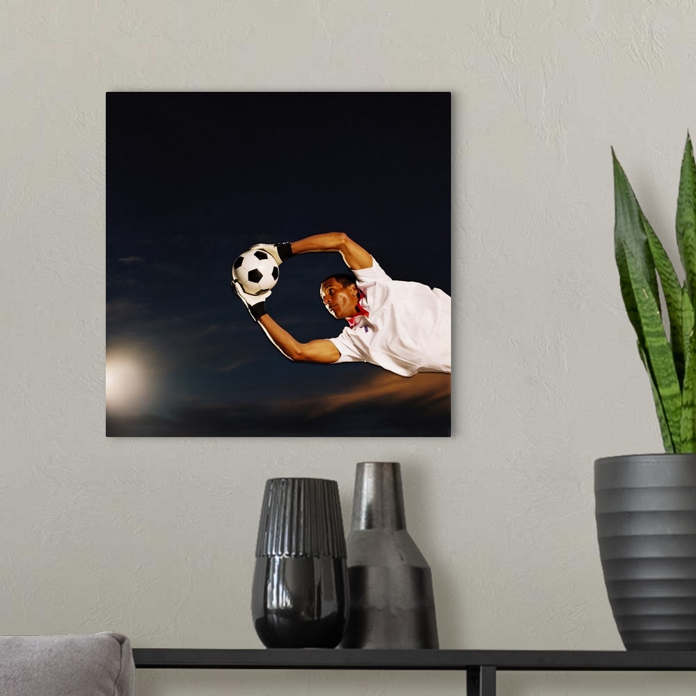 A modern room featuring shot of a soccer goalkeeper making a save
