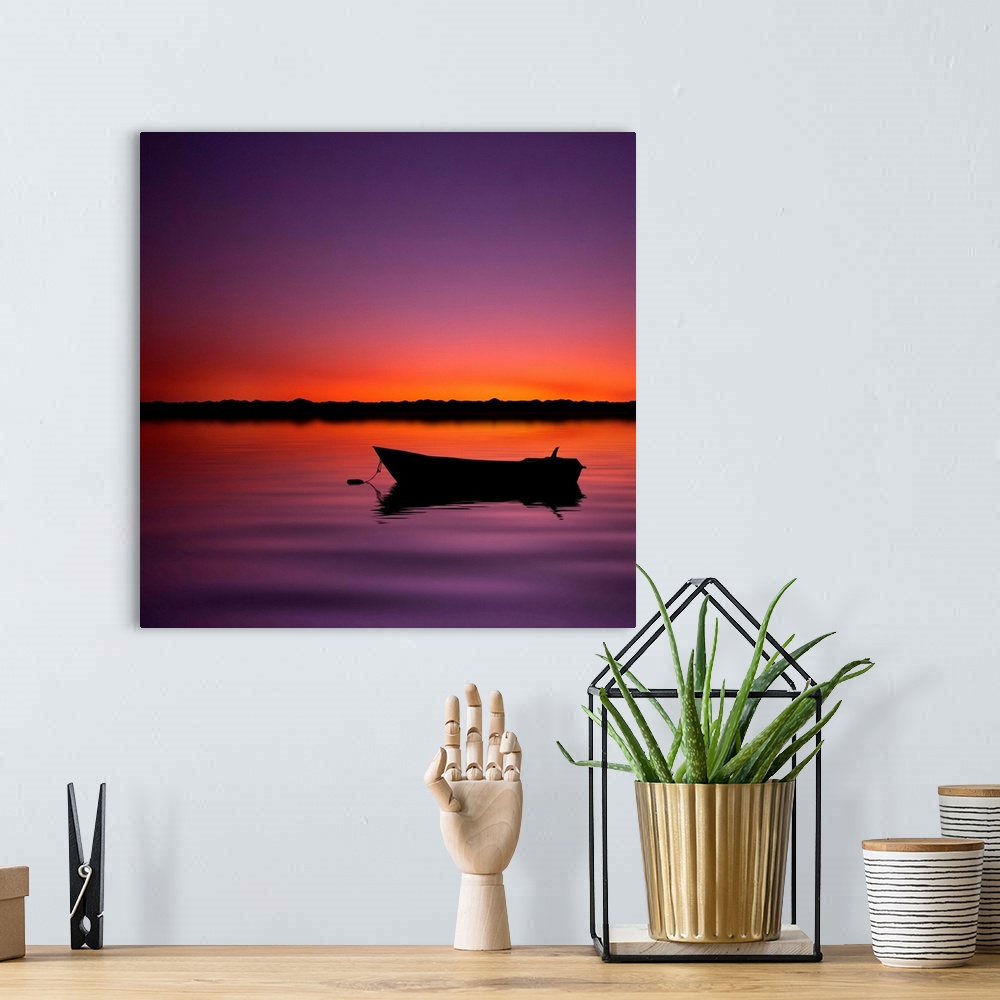 A bohemian room featuring Silhouette boat in lake with sunset.