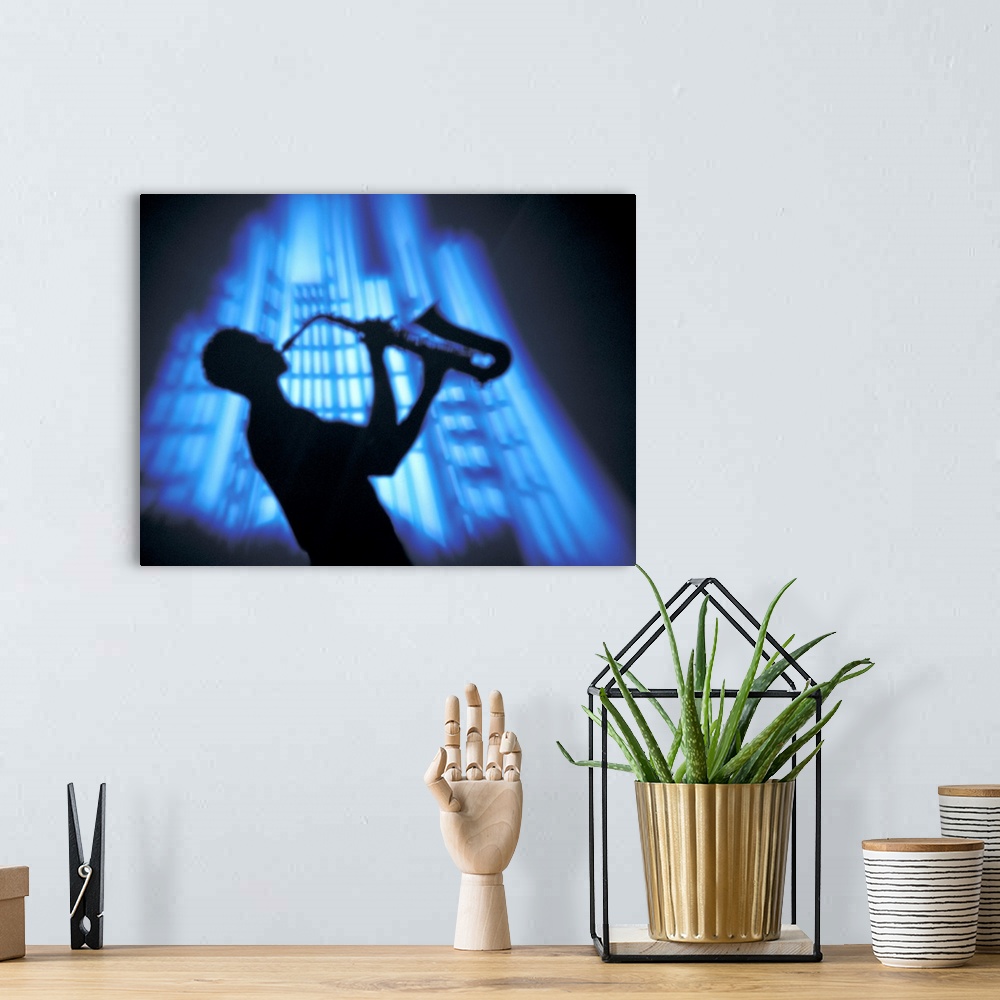A bohemian room featuring Silhouette man lifting sax into air while playing