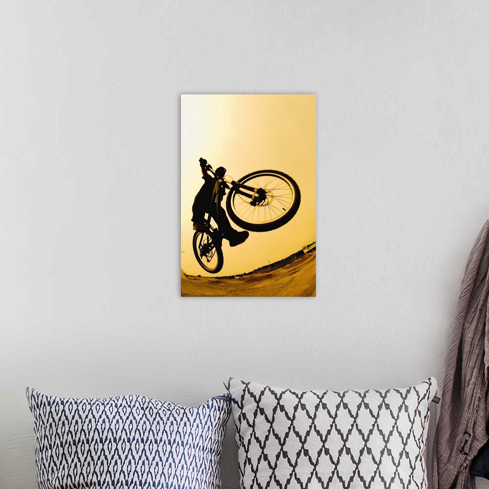 A bohemian room featuring Silhouette of a cyclist against a yellow sky