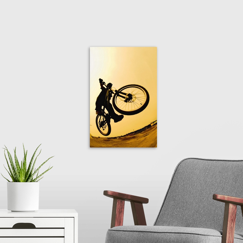 A modern room featuring Silhouette of a cyclist against a yellow sky