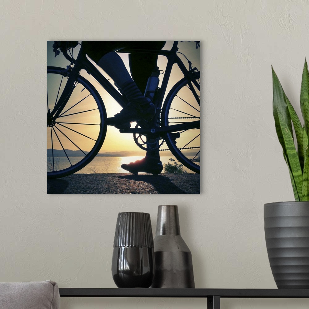 A modern room featuring A cyclist pauses with his road bike to watch the sun rise over Folsom Lake, in Folsom, California...