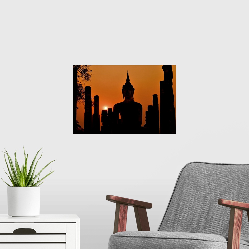 A modern room featuring Silhouette of ancient Buddha statue sitting in middle of ruined temple (illustrated by remaining ...